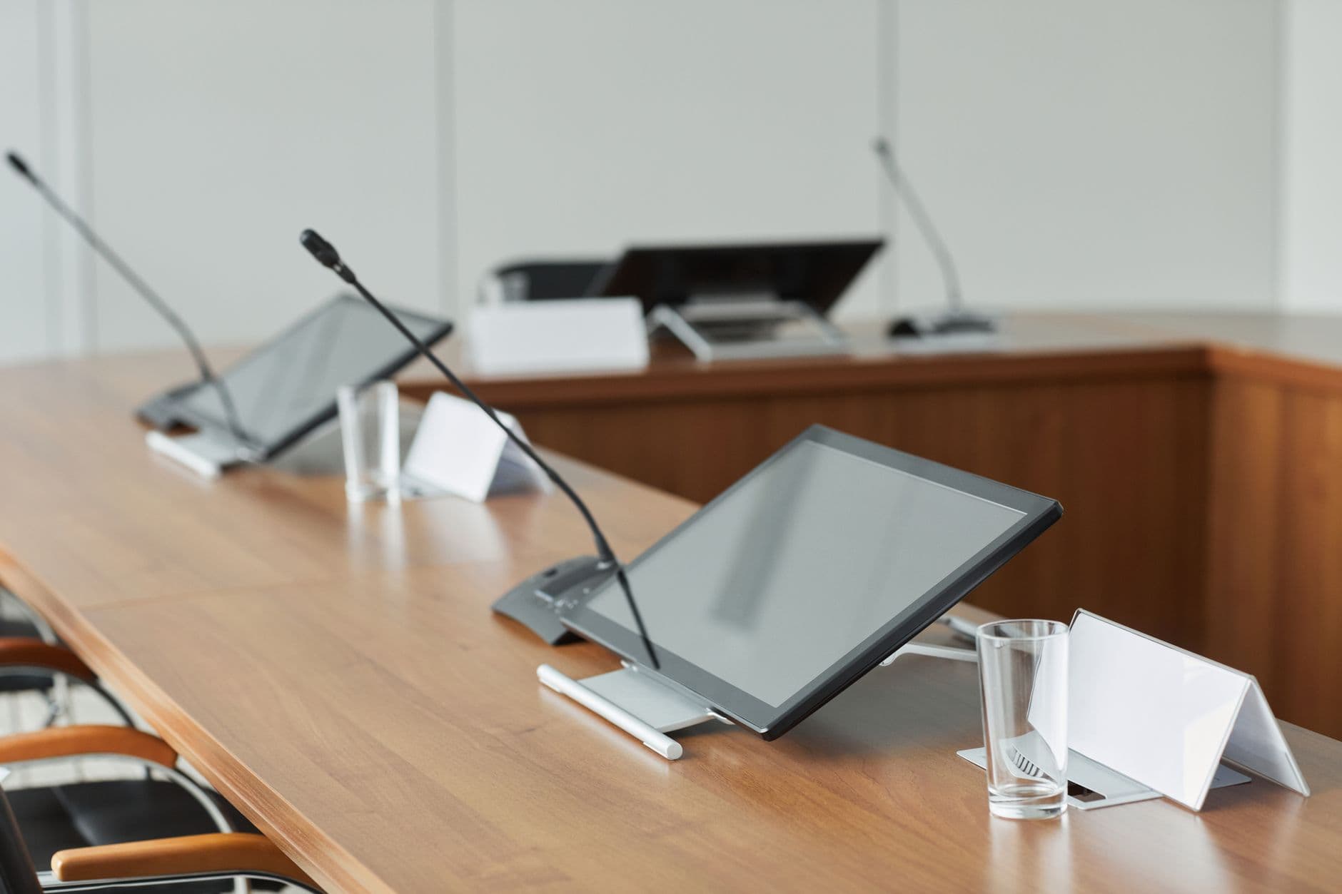 Conference room setup with microphones and monitors for AI analysis of YouTube niches.
