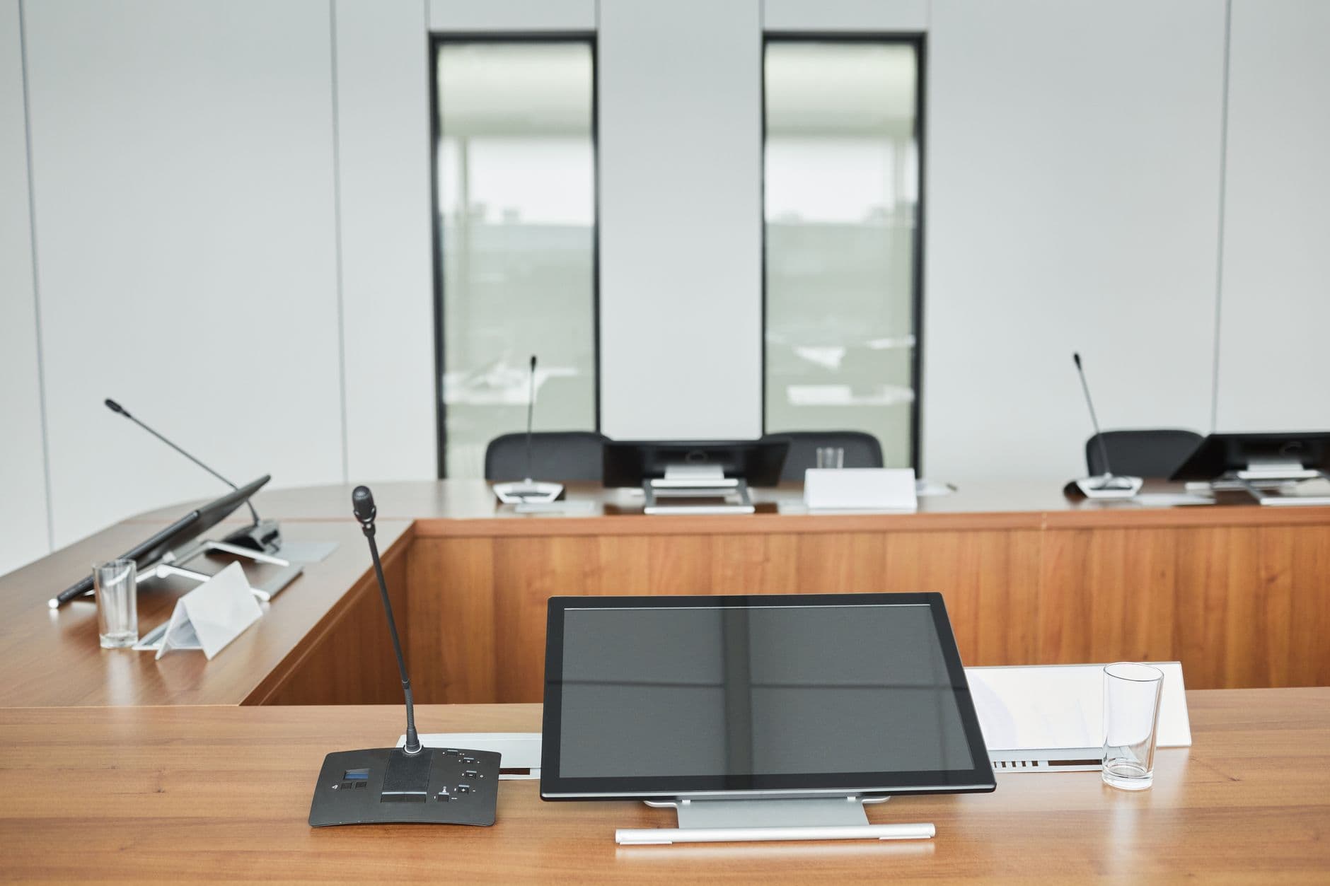 Recording studio desk with microphones, monitors, and glasses for content creation.