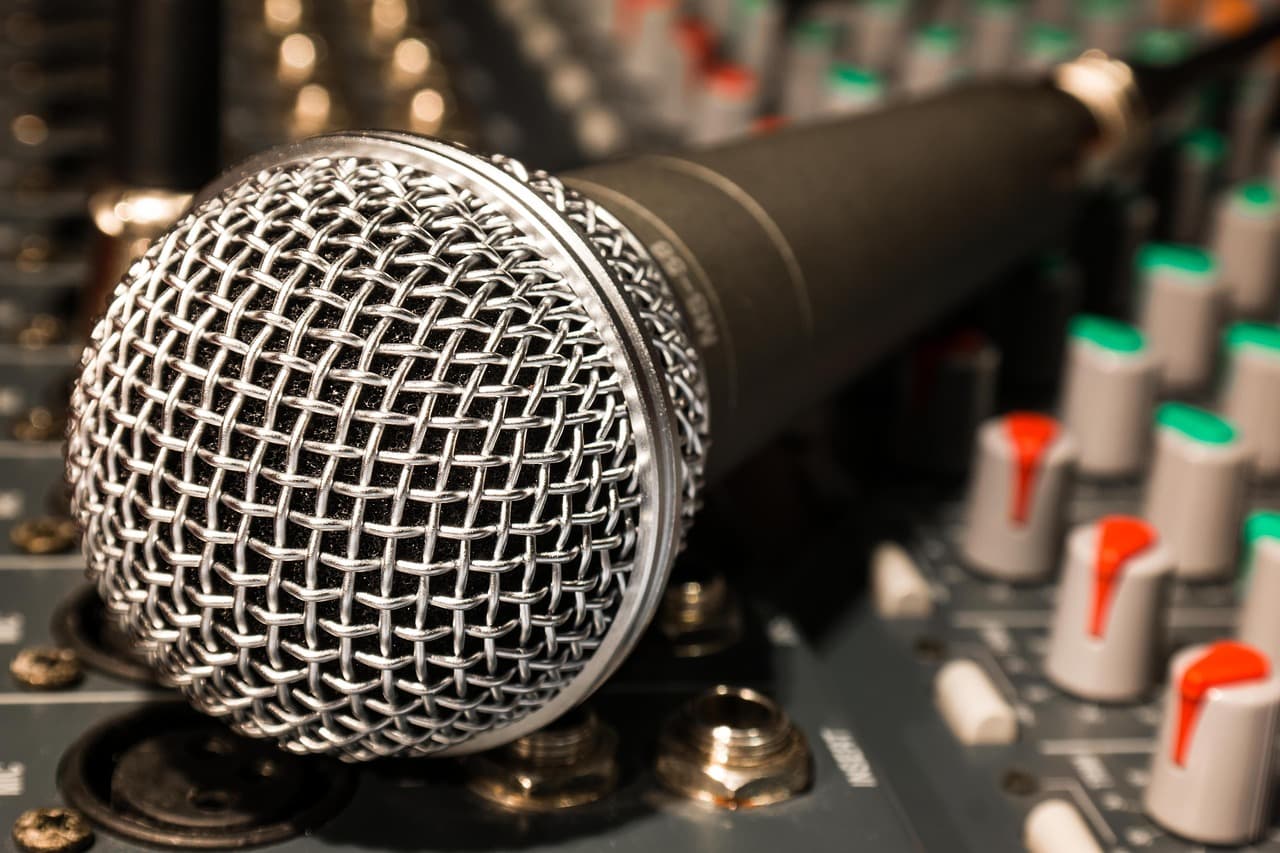 Close-up of a studio microphone on a mixing board, ideal for faceless YouTube creator audio setup.