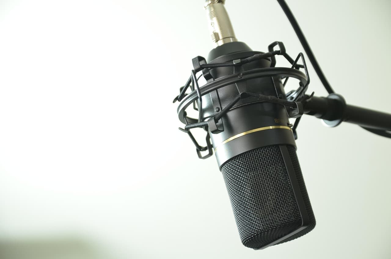 Close-up of a professional microphone with a pop filter, ideal for faceless YouTube audio recording.