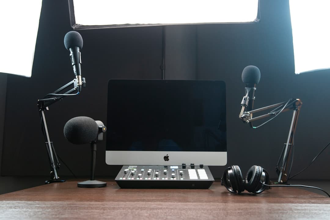 Faceless YouTube creator studio setup with microphones, computer, and audio mixer for content pipeline.