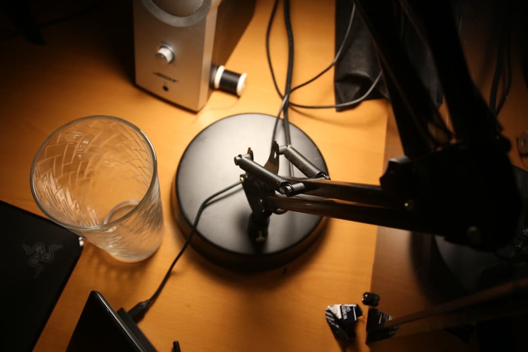 Faceless YouTube creator's desk setup with microphone and audio equipment for video production.