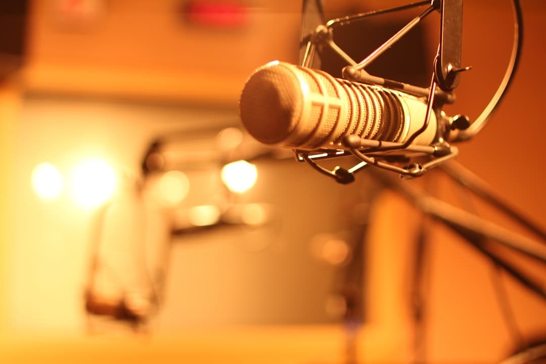 Close-up of a professional studio microphone on a boom arm, suggesting audio production for a faceless YouTube channel.