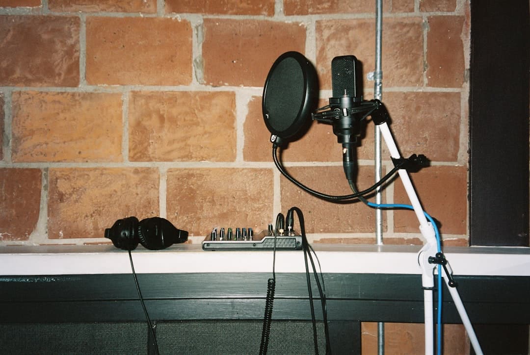 Faceless YouTube creator's audio setup with microphone, headphones, and mixer.