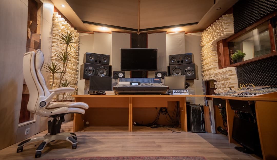 Empty home studio setup with monitors, mixer, and desk for faceless YouTube content creation.