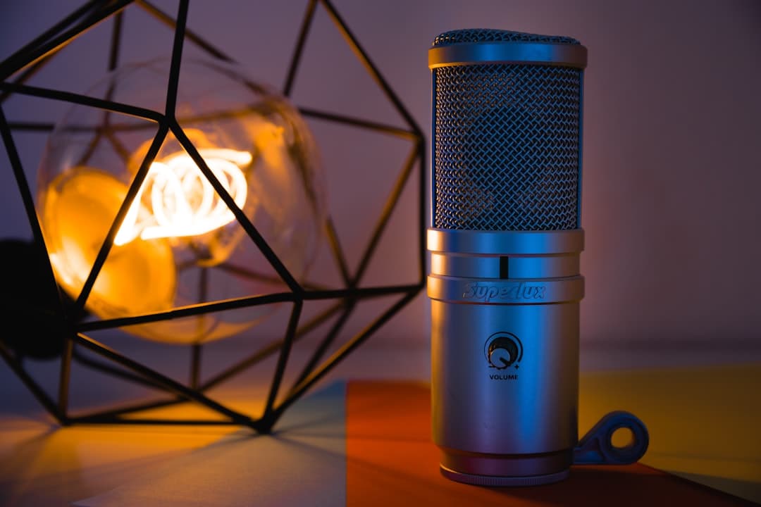 Studio microphone and decorative lamp on a colorful surface, suggesting a creator's workspace.