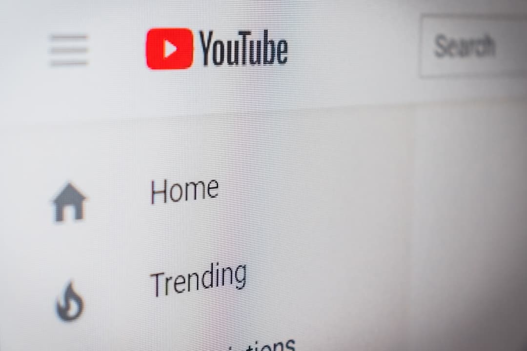 Close-up of YouTube homepage on a computer screen, showing navigation and trending content.
