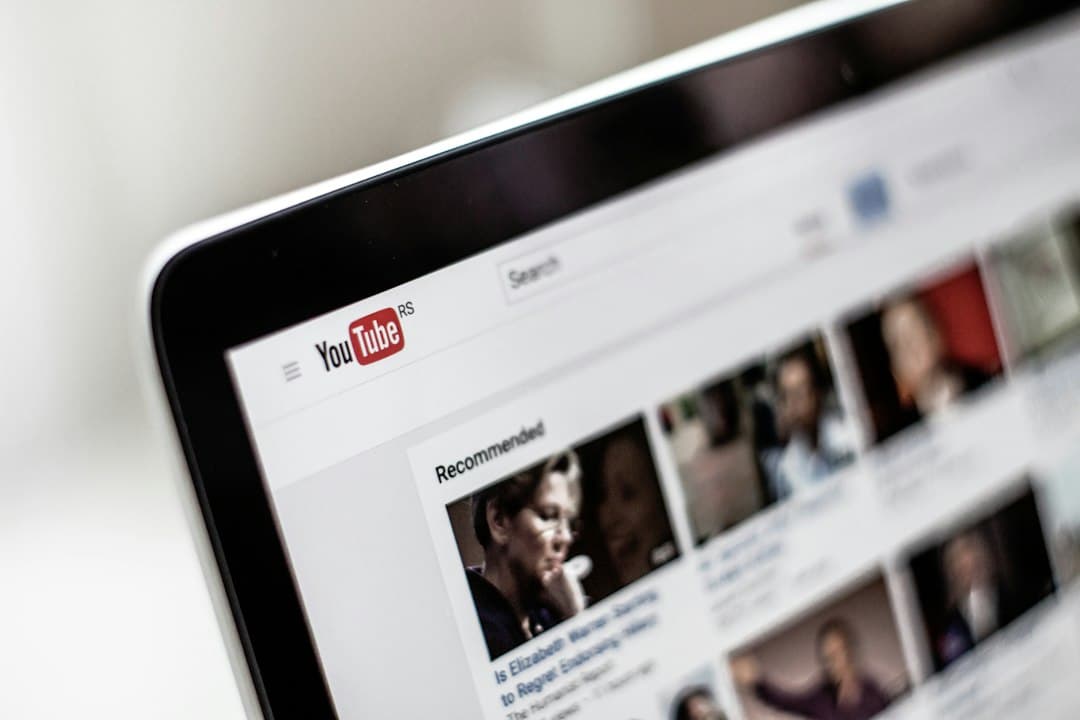 Laptop screen displaying YouTube interface and recommended videos for content strategy.